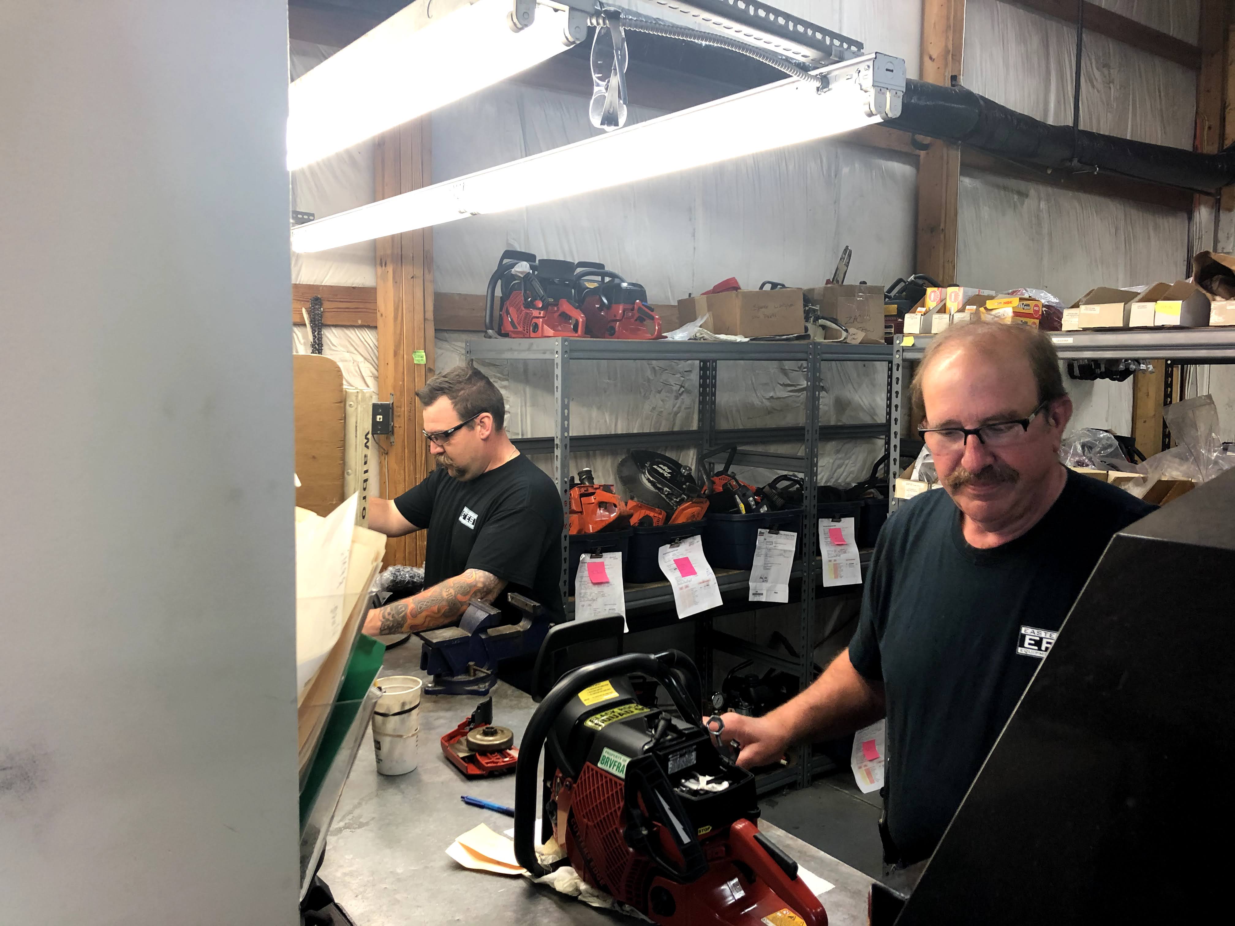An EFES technician repairing rescue saw equipment in the shop