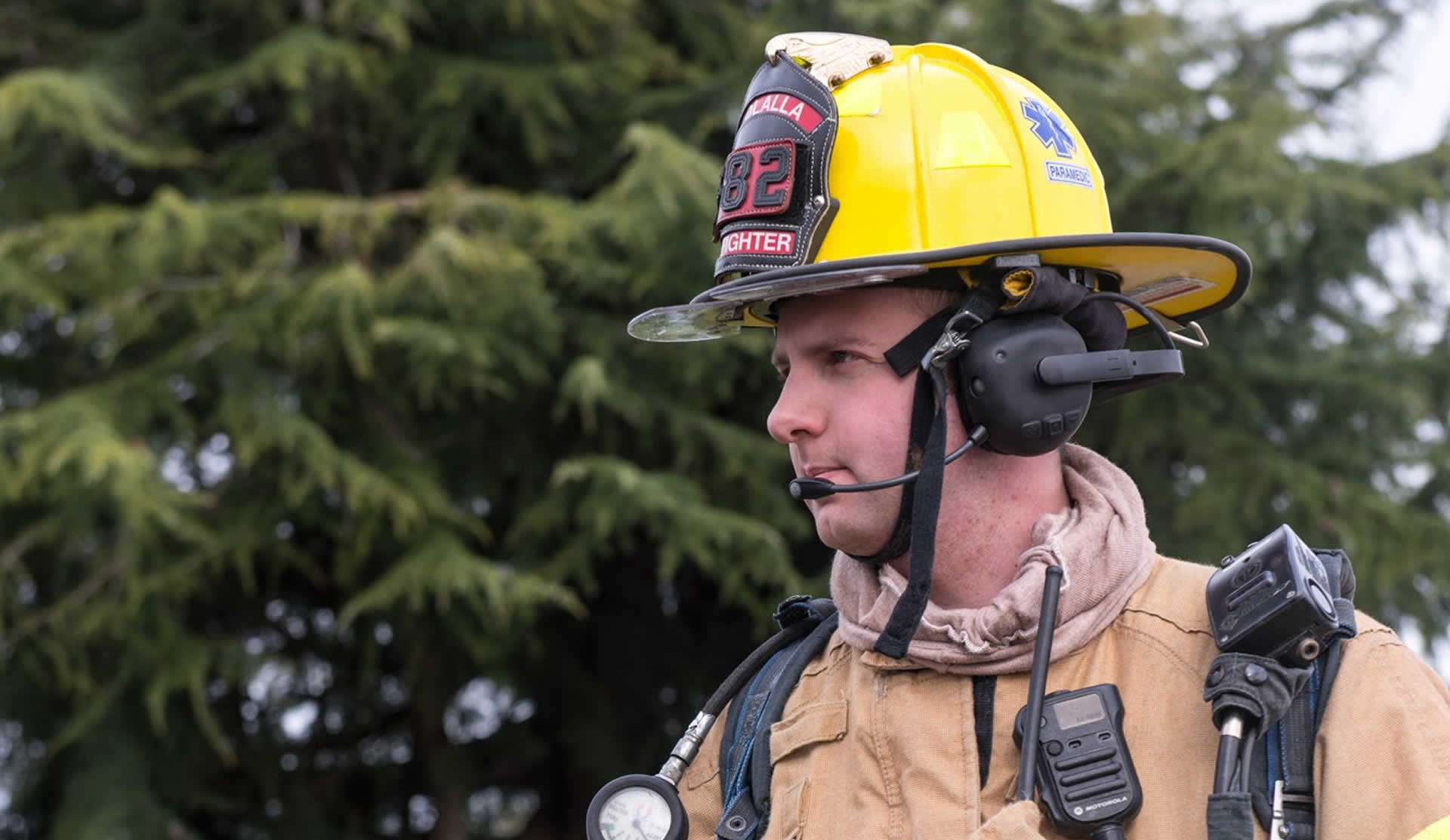 Firefighter wearing a FIRECOM communication headset on scene
