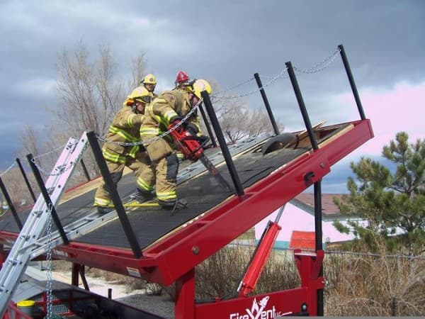 Firefighters performing roof ventilation with a rescue saw