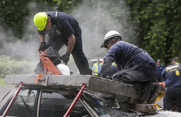Firefighters cutting through a roof during ventilation operations