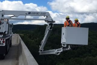 Work crew wearing Sonetics Apex wireless headsets on a high-noise job site
